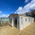 Static Caravan with large decking and blue sky
